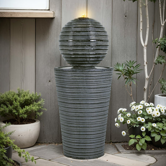 Gray concrete column fountain with striped finish, outdoor decor by Anthony & Home, showcasing a limited edition garden feature.