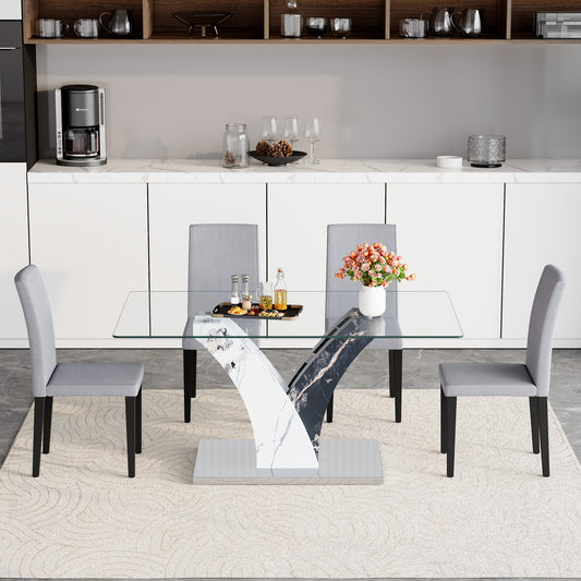 Modern dining table with tempered glass top and artistic MDF legs, paired with four light gray linen-cotton chairs.