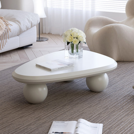 Creamy white lacquered MDF Cloud coffee table with studio teardrop top and three ball legs by Anthony & Home.