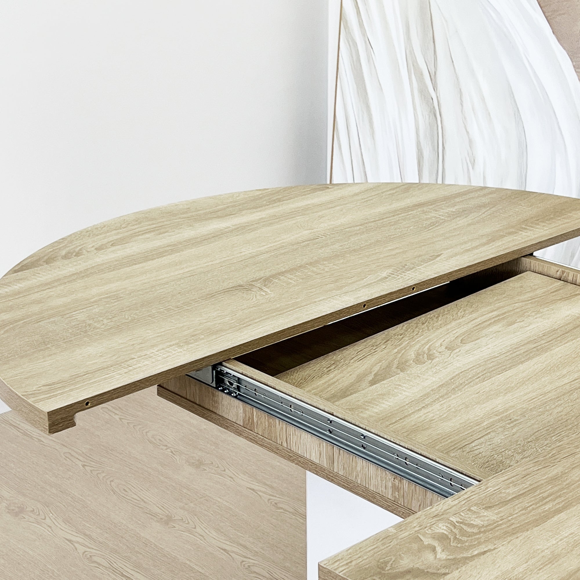 White Oak Edition oval dining table with expandable leaf by Anthony & Home, showing a spacious wooden table with a smooth finish.