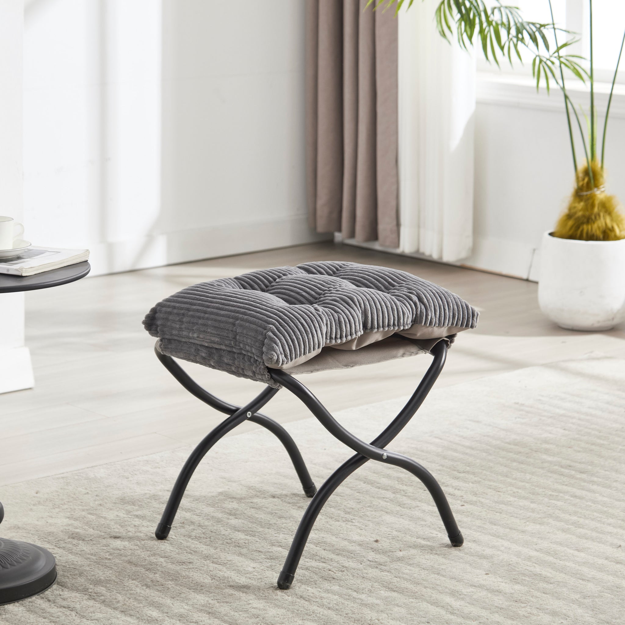 Grey upholstered lounge chair with matching ottoman and armrests, stylish and comfortable for modern living spaces.