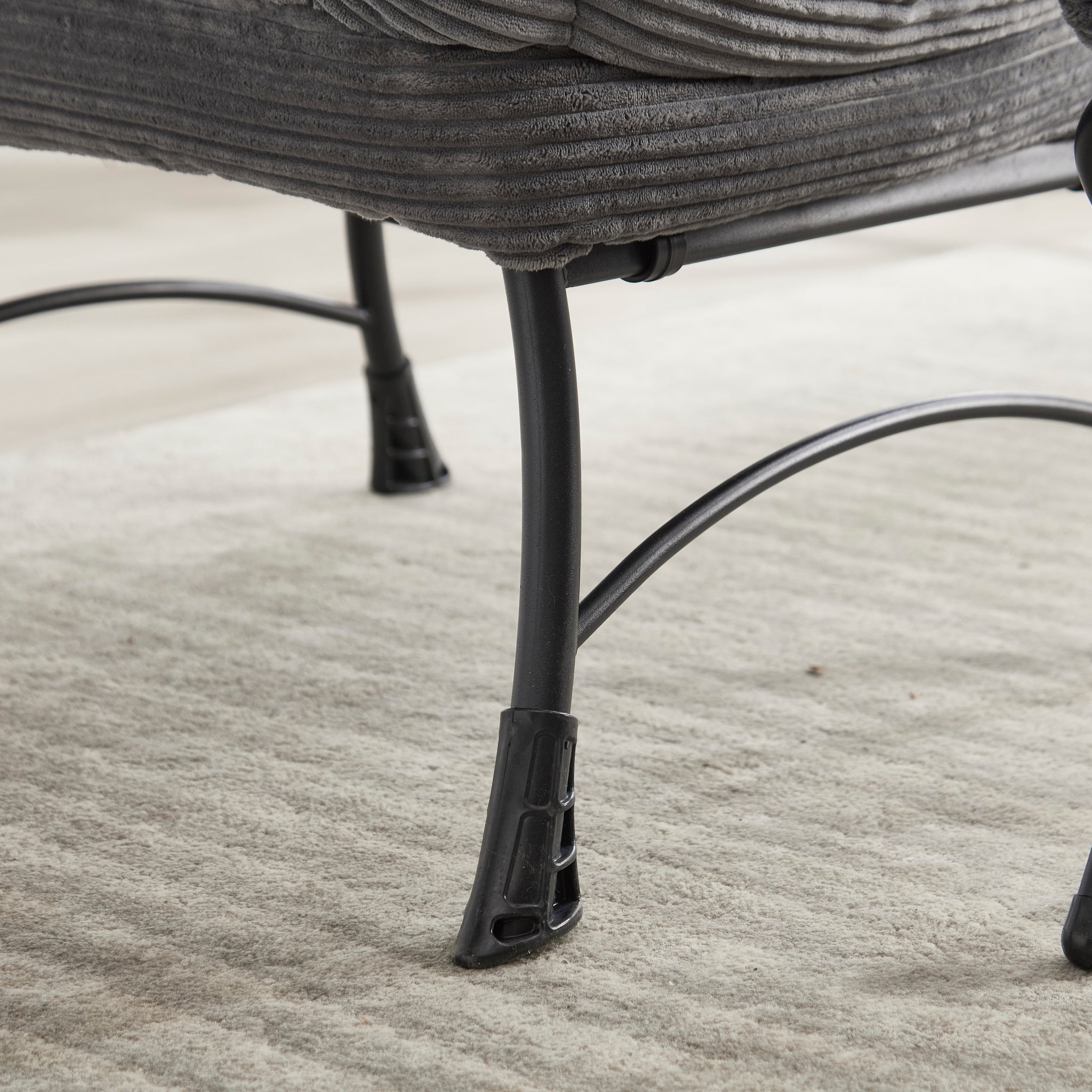 Grey upholstered lounge chair with matching ottoman and armrests, modern design by Anthony & Home for comfortable relaxation.