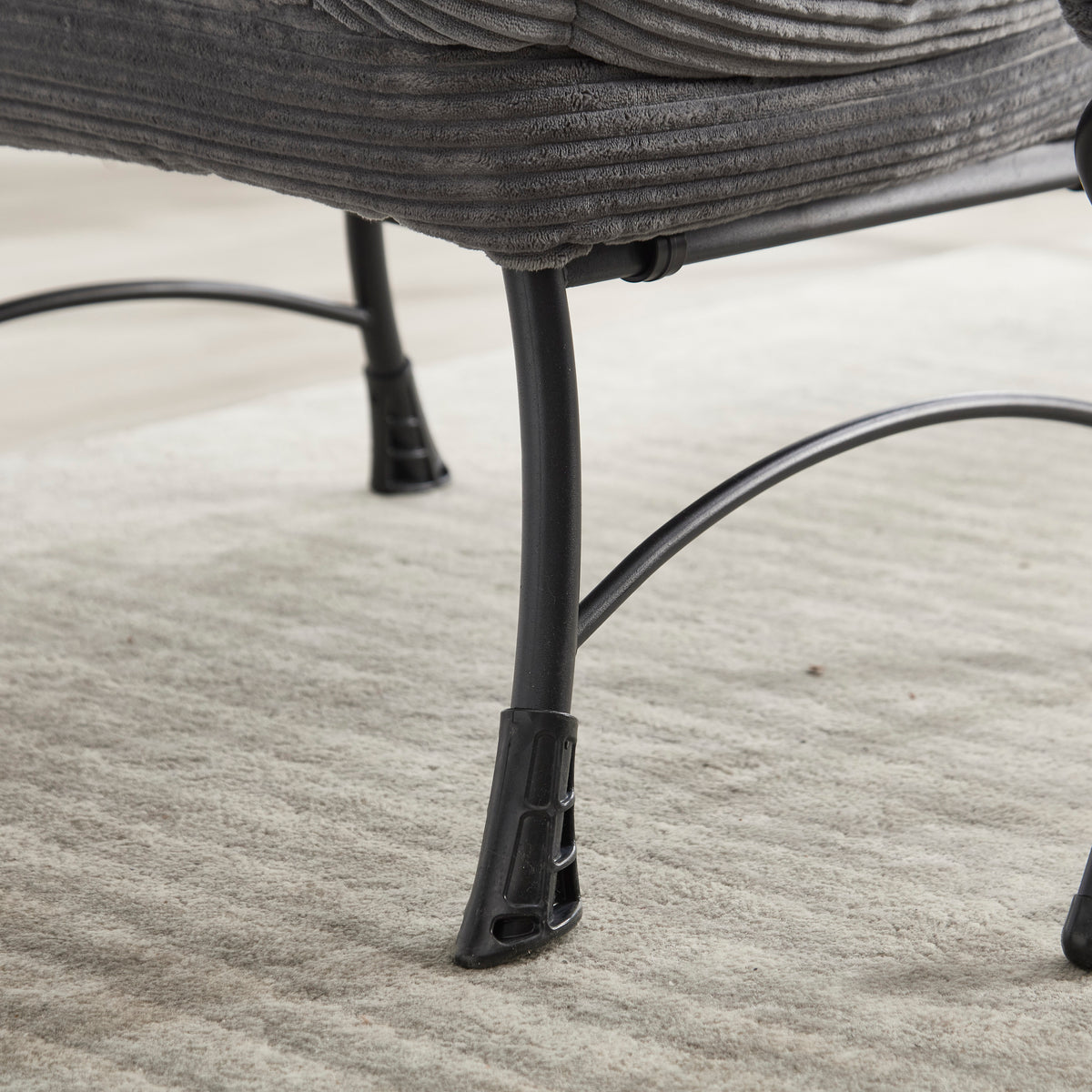 Grey upholstered lounge chair with matching ottoman and armrests, modern design by Anthony & Home for comfortable relaxation.