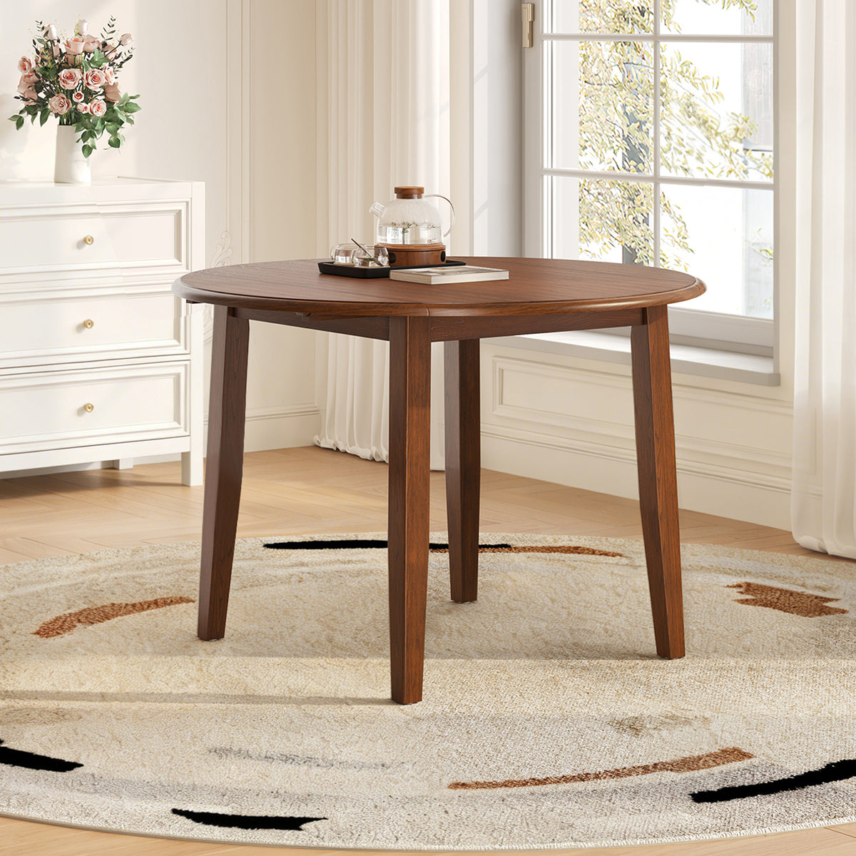 Anthony & Home Atelier Walnut Extendable Round Dining Table with 2-4 seating, showcasing smooth wood surface and elegant design.