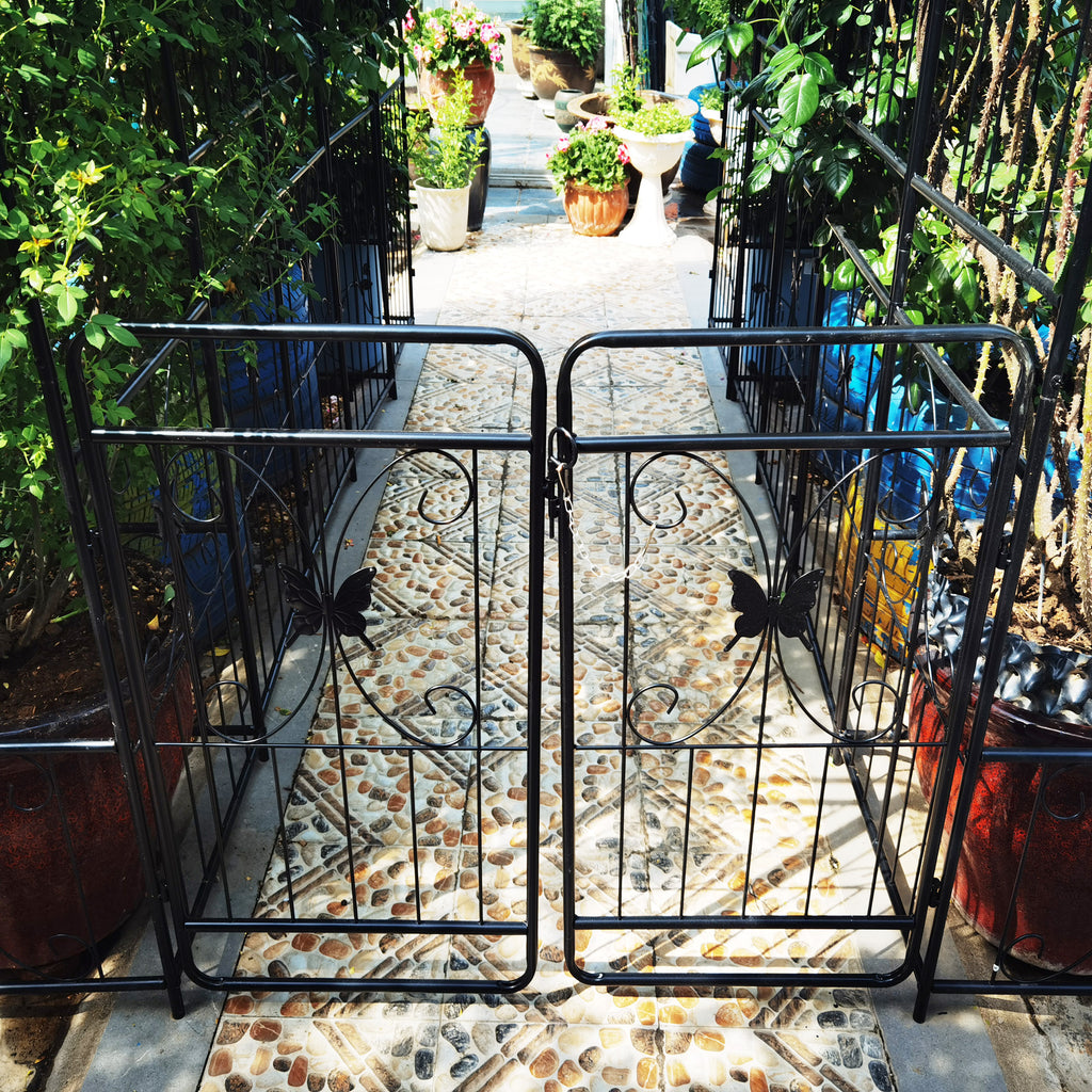 Black metal garden arch with gate, 80 inches wide and 86 inches high, rose arbor style by Anthony & Home.