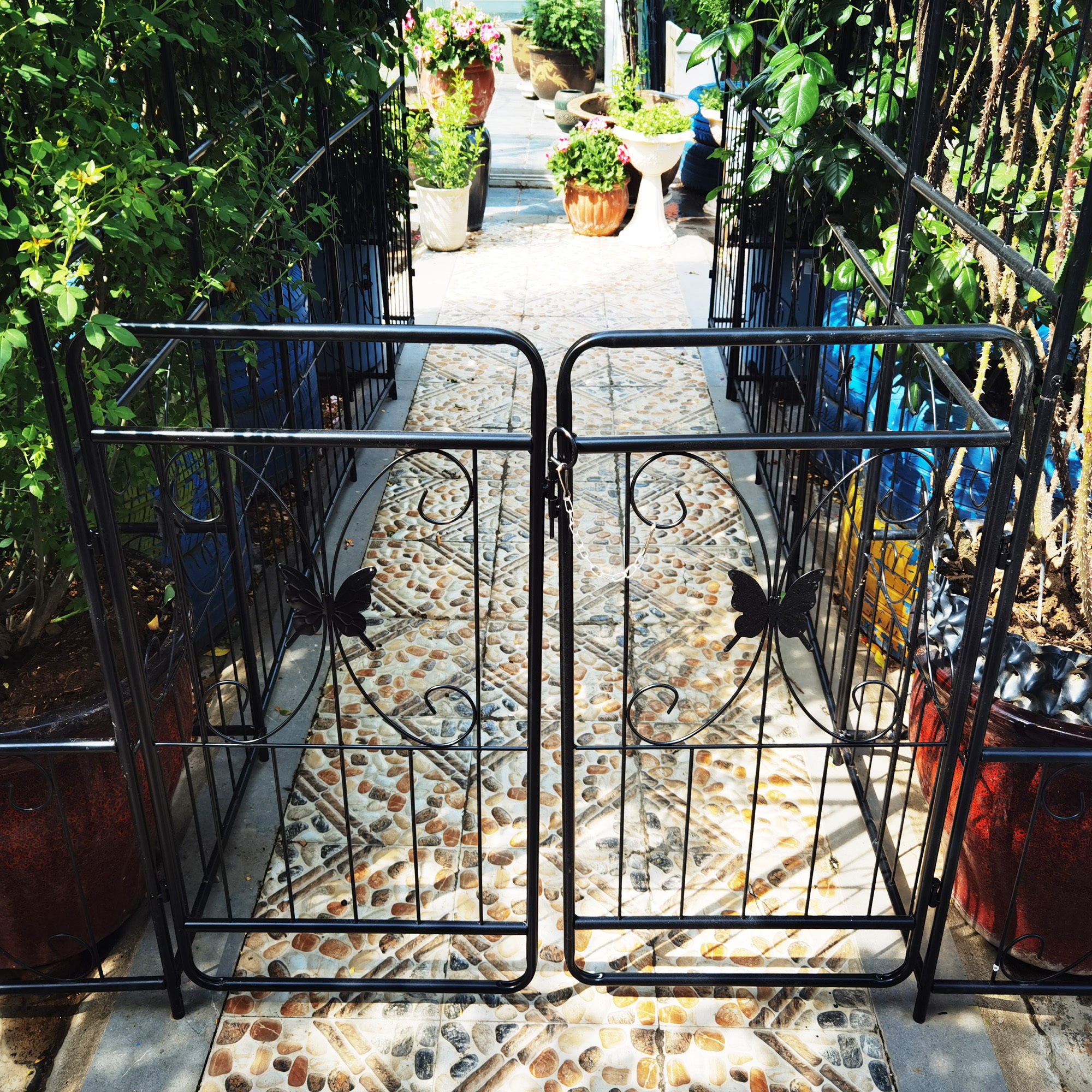 Black metal garden arch with gate, 80 inches wide and 86 inches high, rose arbor style by Anthony & Home.
