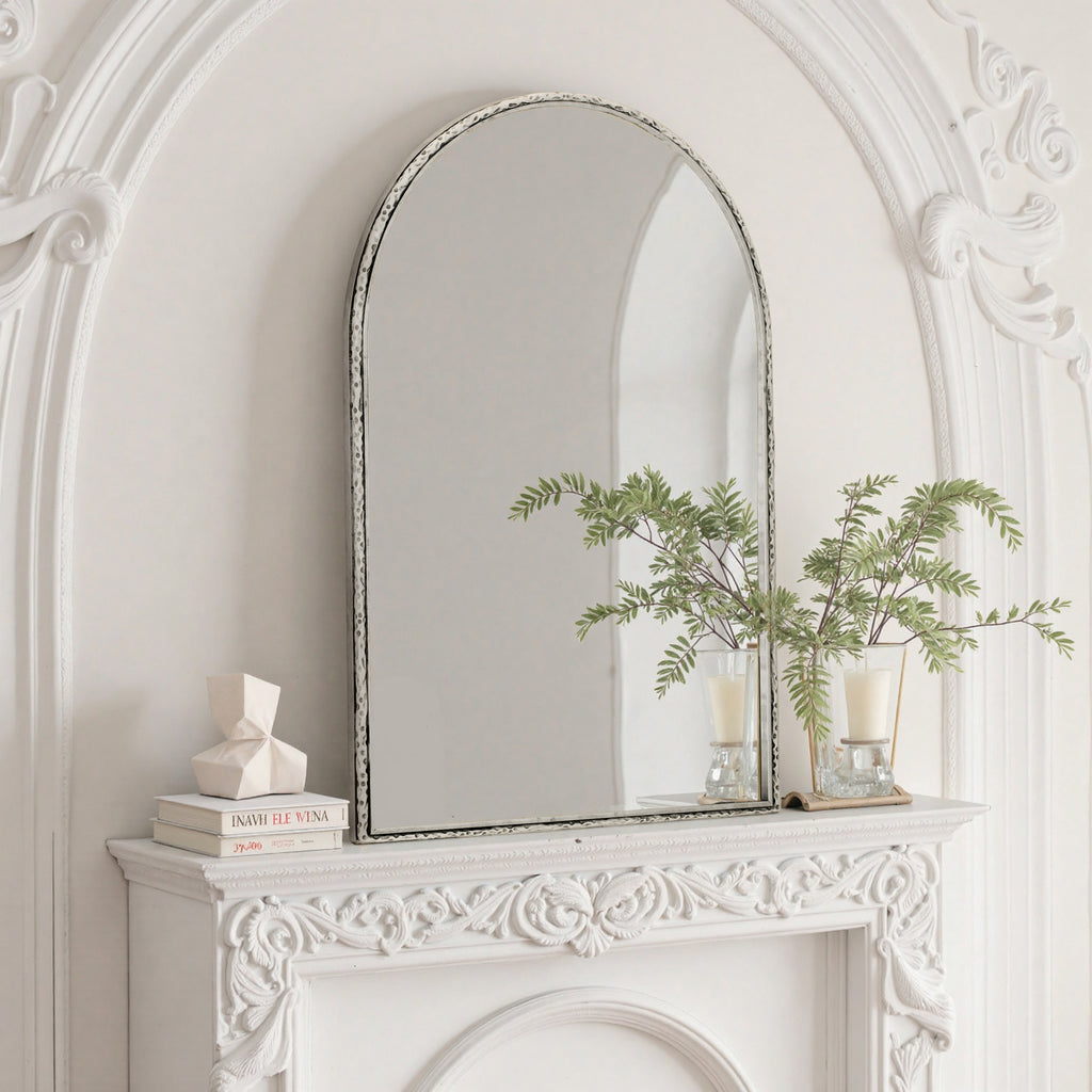 Arched silver mirror with tempered glass frame from Anthony & Home, reflecting a modern interior design.