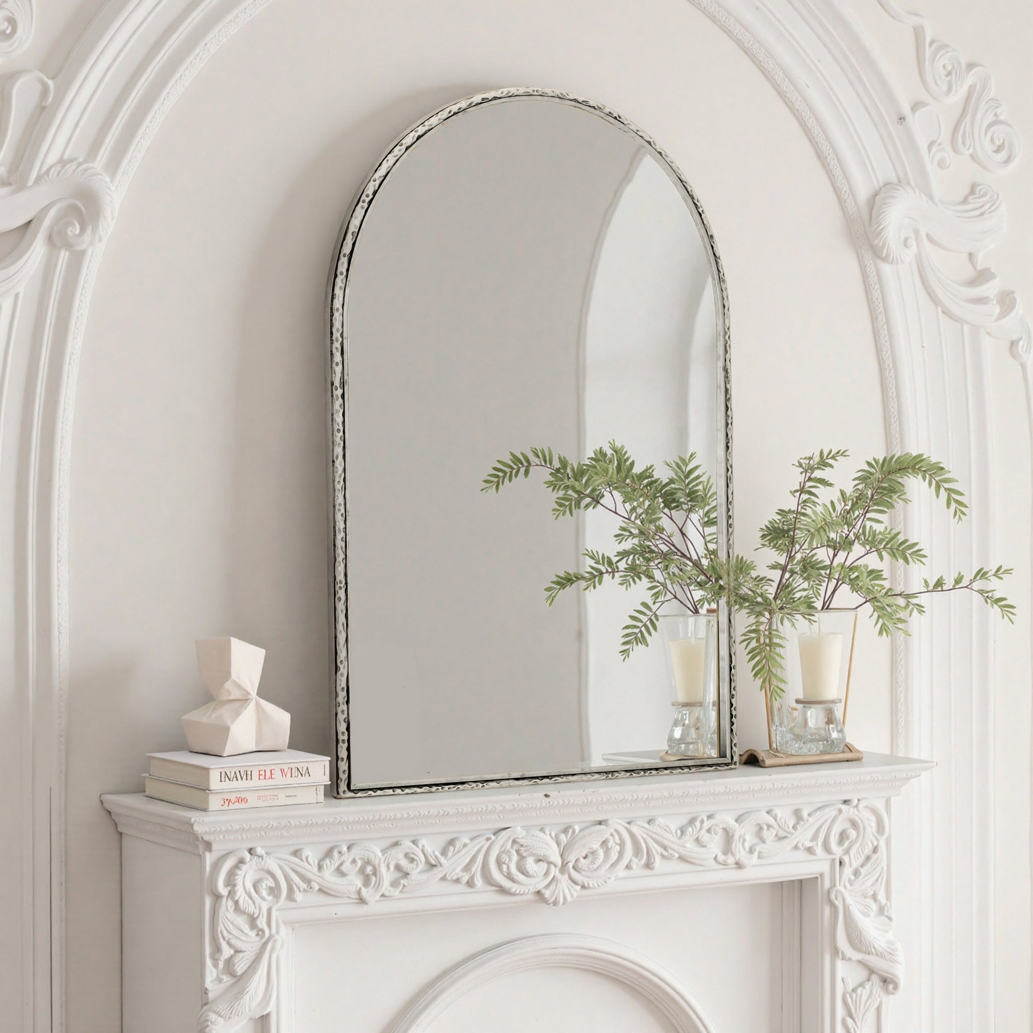 Arched silver mirror with tempered glass frame from Anthony & Home, reflecting a modern interior design.
