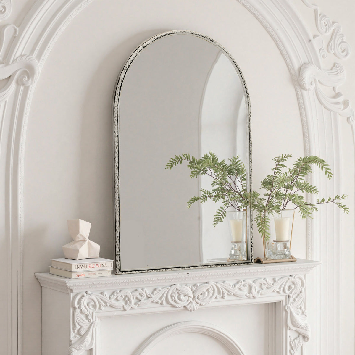 Arched silver mirror with tempered glass frame from Anthony & Home, reflecting a modern interior design.
