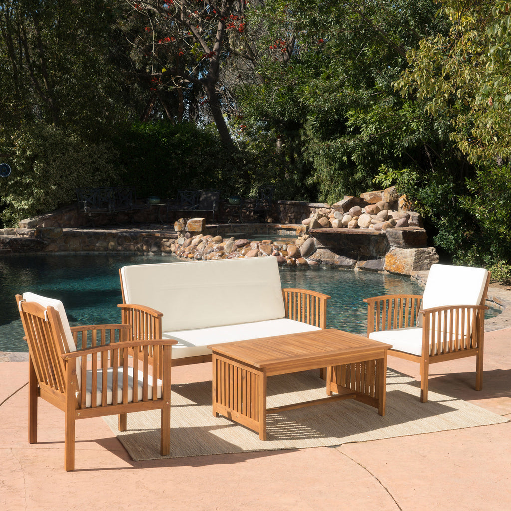 Acacia wood outdoor chat set with water-resistant cushions, featuring a rectangular table and comfortable seating for outdoor lounging.