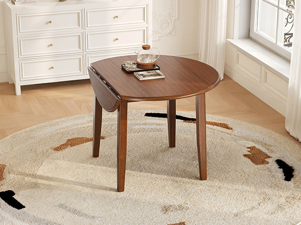 Anthony & Home Atelier Walnut extendable round dining table with 2-4 setting, showcasing polished wooden surface and elegant design.