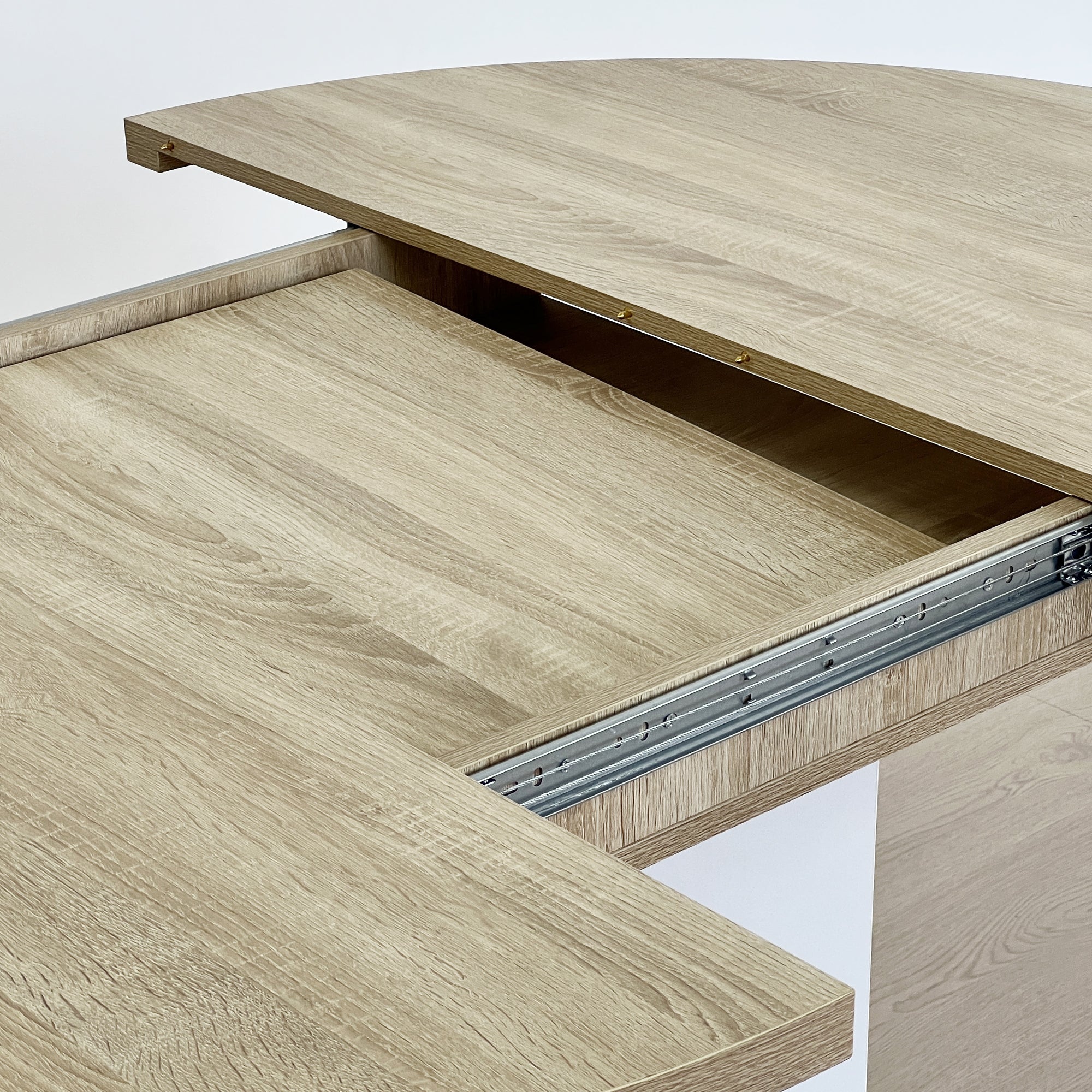 White Oak Edition oval dining table with expandable leaf by Anthony & Home, featuring a polished wood surface and sturdy legs.