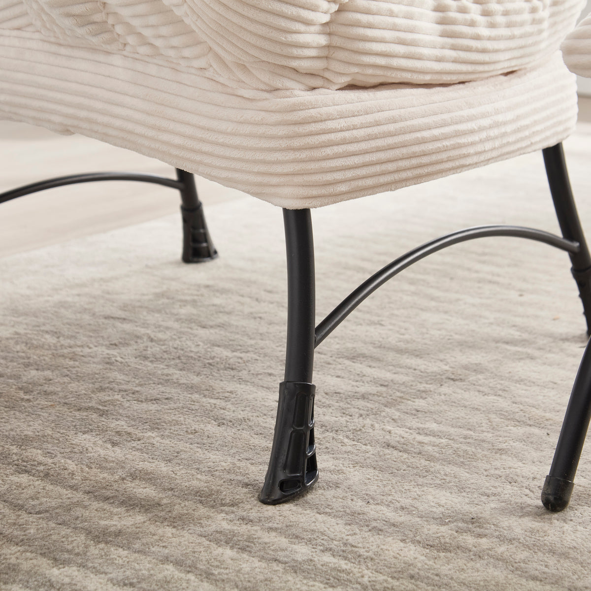 Ivory upholstered lounge chair with matching ottoman and side pocket, modern reading nook accent by Anthony & Home.