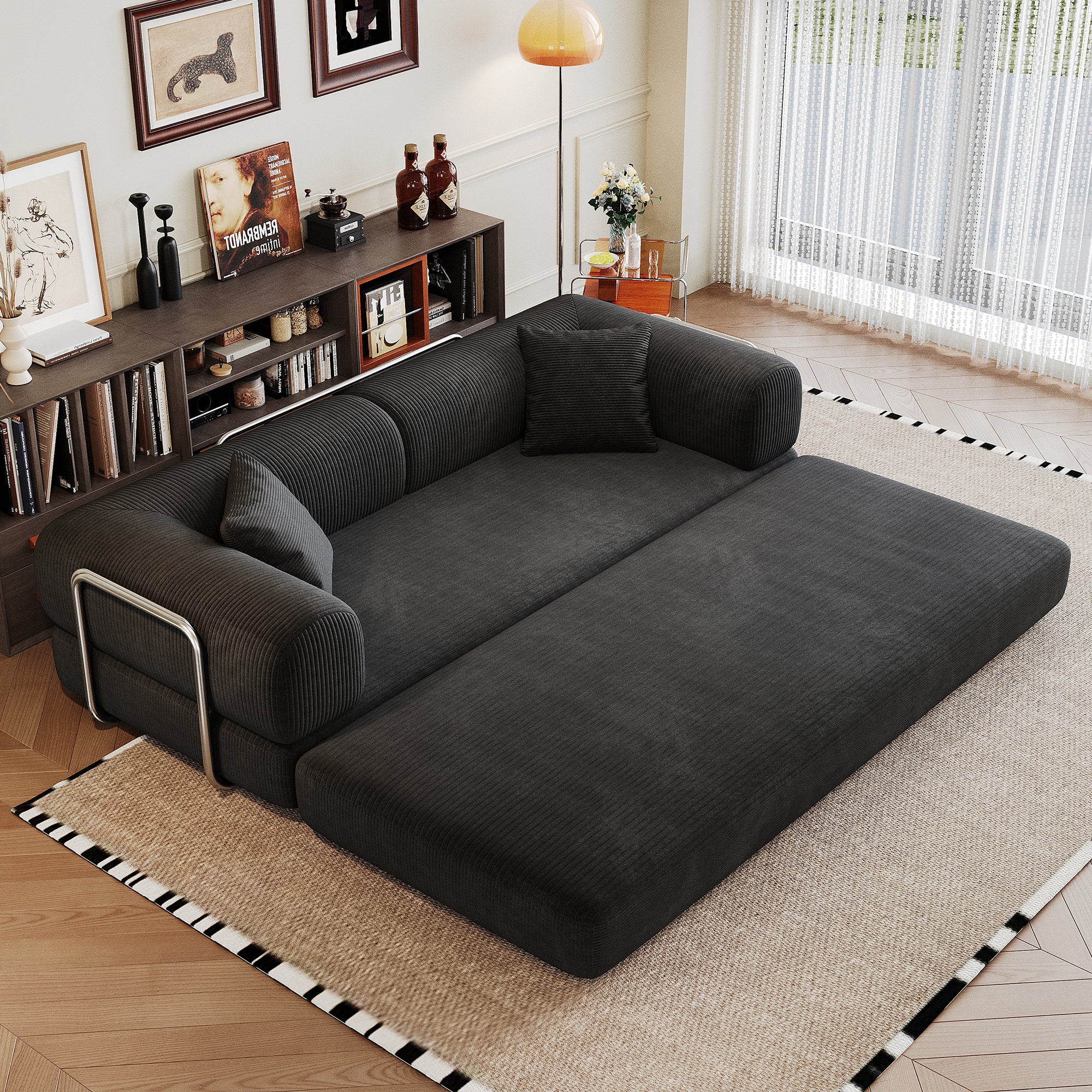 Black corduroy convertible sofa bed from Anthony & Home's Atelier Collection, showing its sofa and bed configurations.