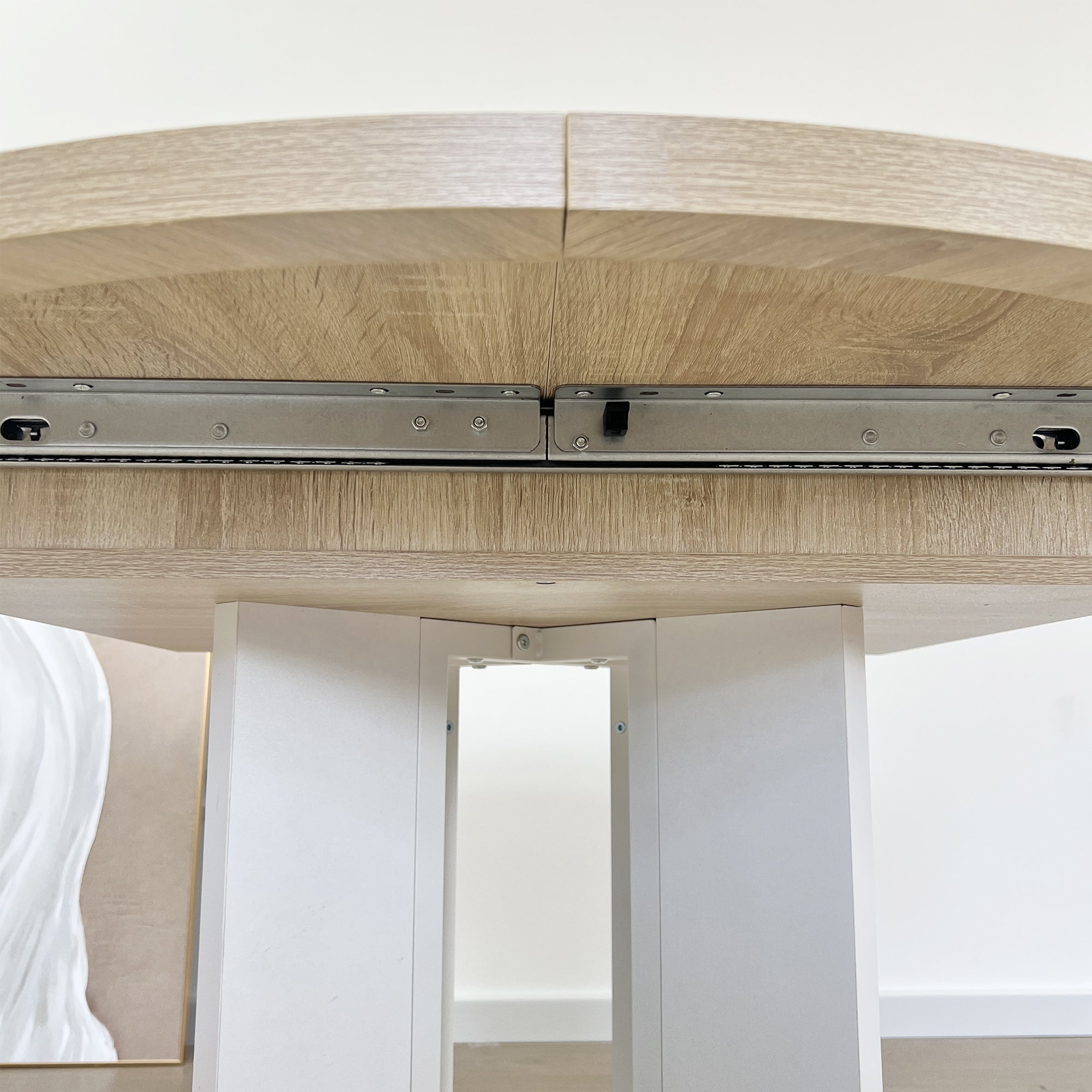 White Oak Edition oval dining table with expandable leaf by Anthony & Home, showing the smooth wooden surface and elegant design.