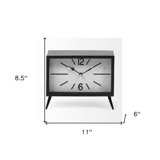 Rectangular black metal wall clock with minimalist design, HomeRoots brand, featuring a sleek and modern look.