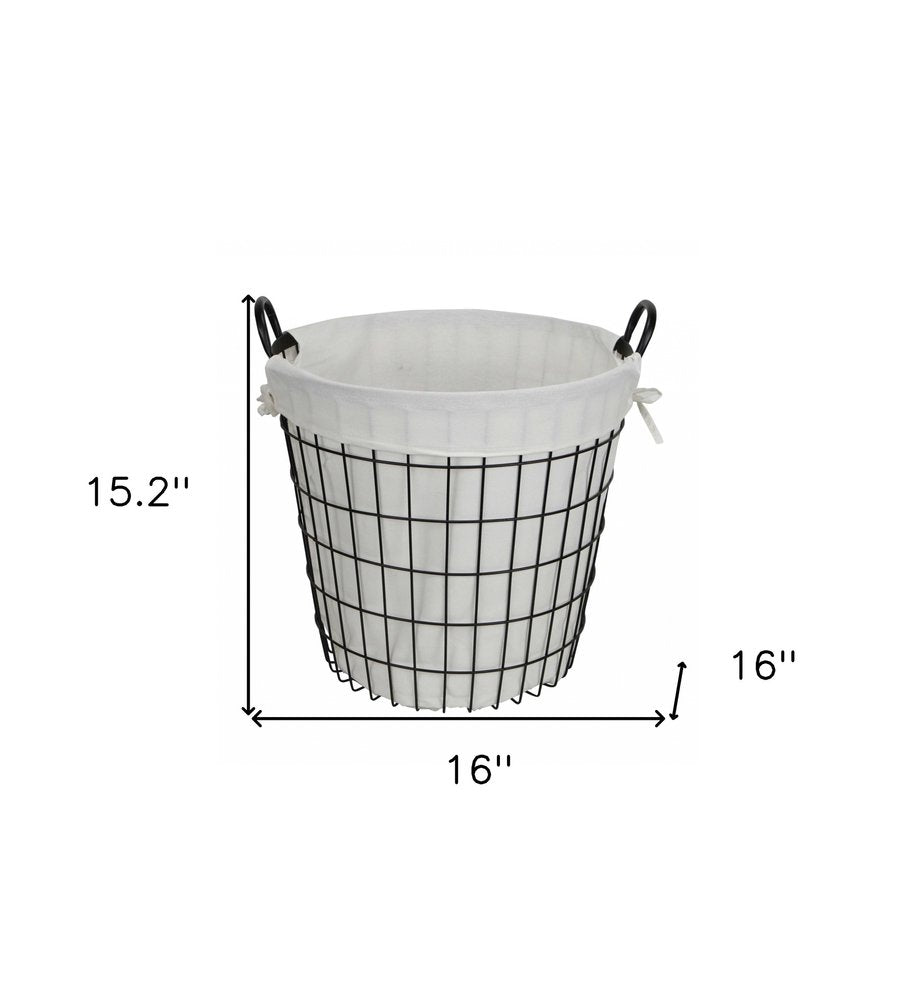 White fabric-lined metal laundry basket with handle, HomeRoots organizer for laundry or storage, showing sturdy construction and handles.