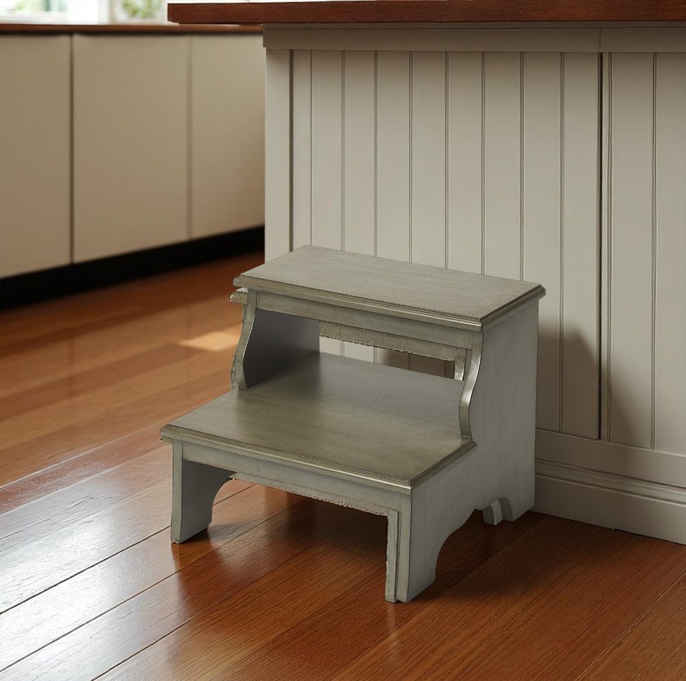 18-inch handcrafted silver satin step stool from HomeRoots, featuring a sturdy ladder design with a sleek, polished finish.