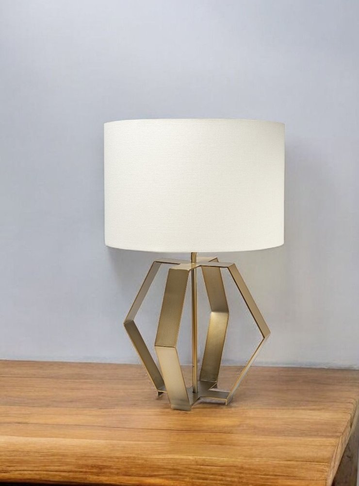 Gold geometric design table lamp with a sleek base and textured shade, perfect for modern decor.