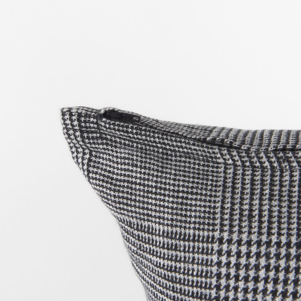 White and black patterned accent throw pillow cover from HomeRoots featuring a modern geometric design.