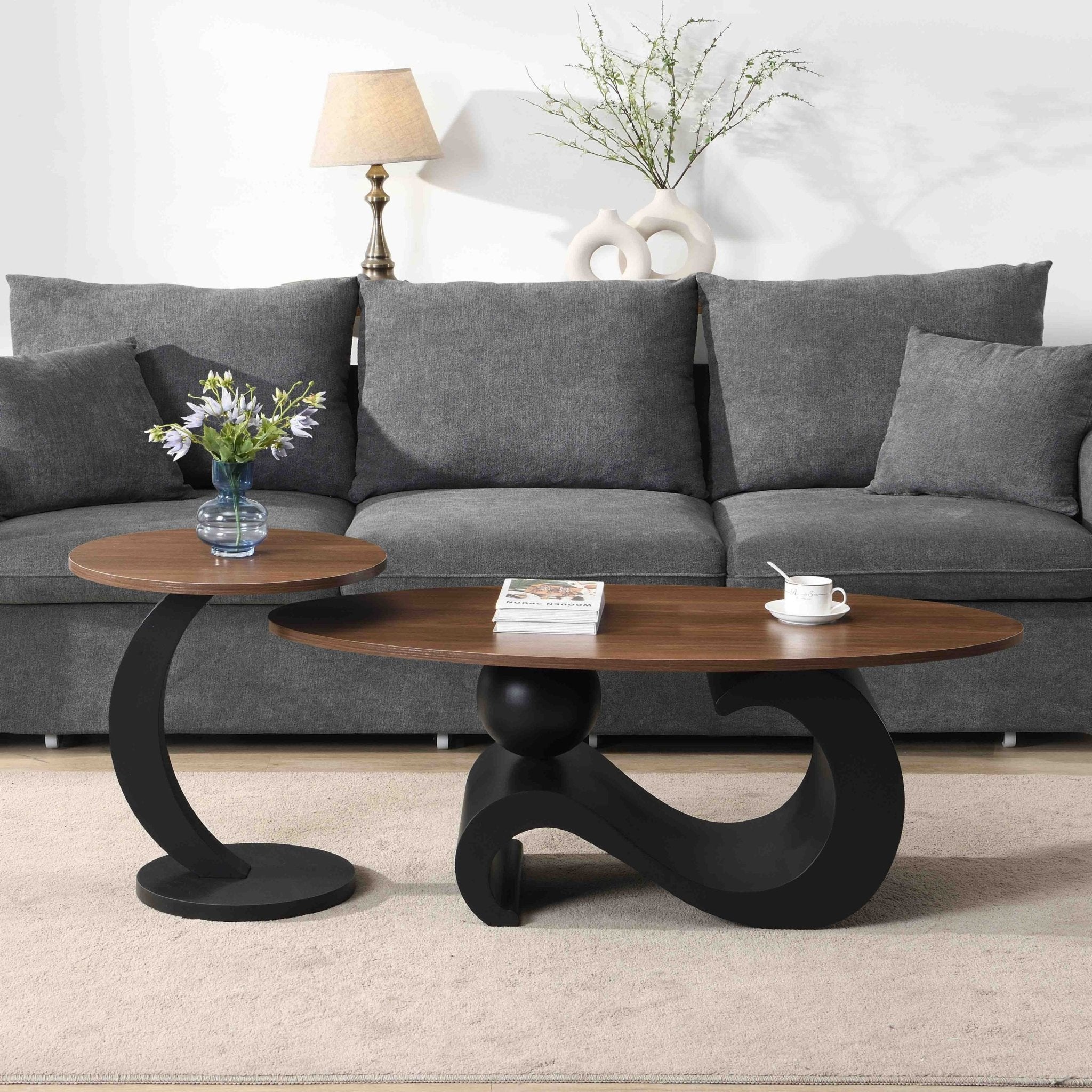 Set of black MDF nesting coffee tables with metal bases by Anthony & Home, showing sleek, modern design and stacked arrangement.