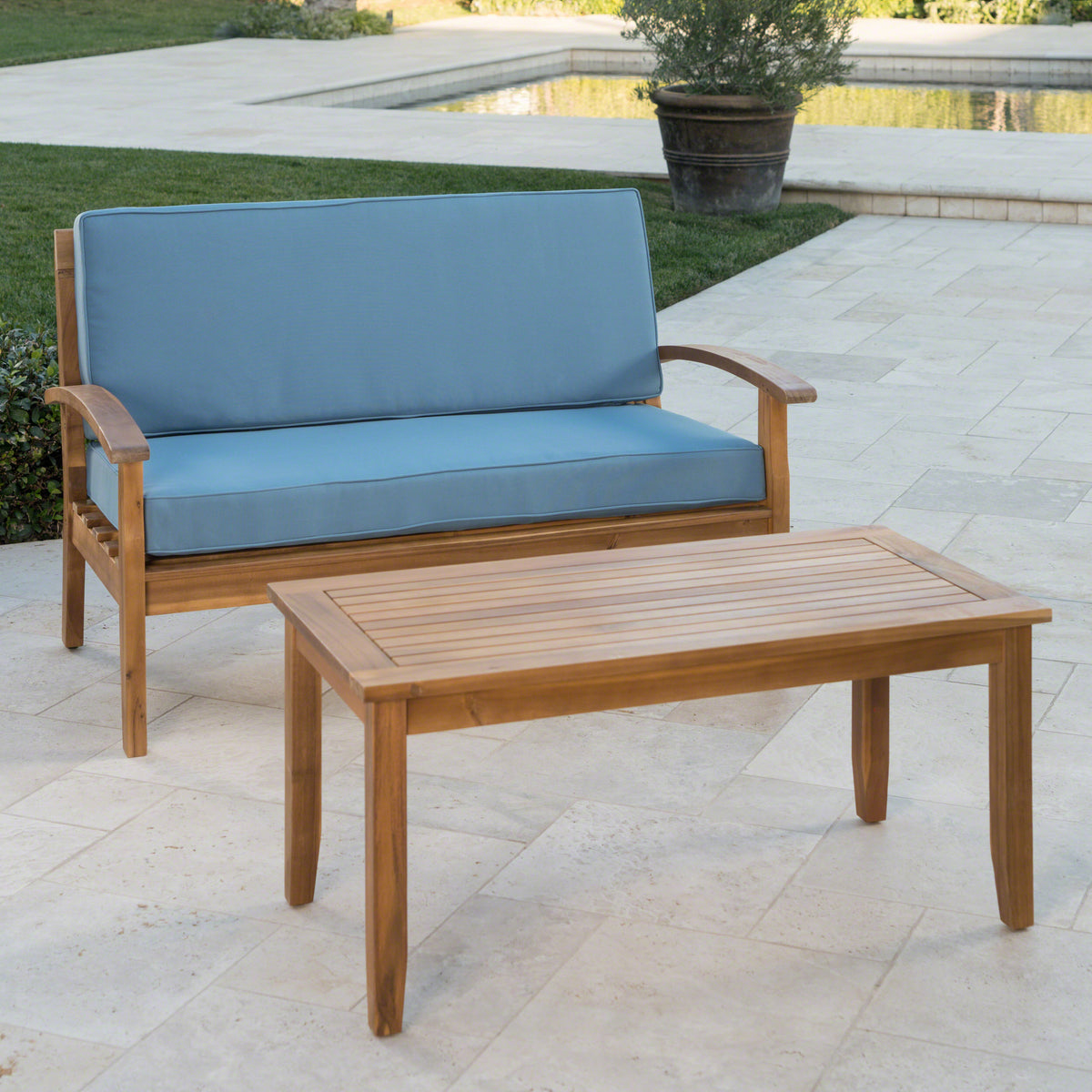Anthony & Home teak outdoor chat set with coffee table and loveseat from the Atelier Collection, handcrafted finish.