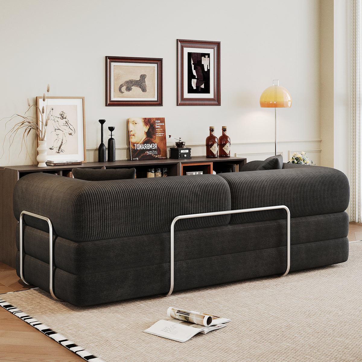 Black corduroy convertible sofa bed from Anthony & Home's Atelier Collection, showing the sofa in its seated and bed configurations.