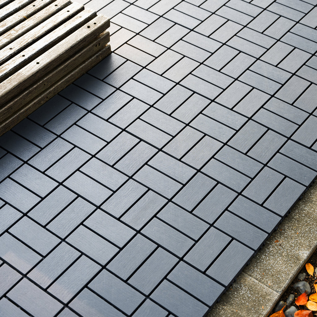 Grey polypropylene interlocking deck tiles, 44-pack of 12x12 inch tiles by Anthony & Home, shown assembled on outdoor surface.