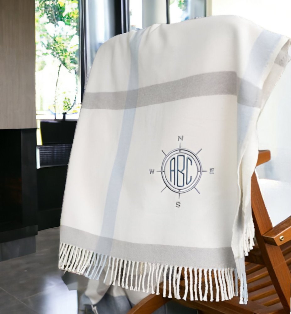 Blue plaid throw blanket with tassels from HomeRoots, soft plush fabric, perfect for cozying up on the sofa or bed.