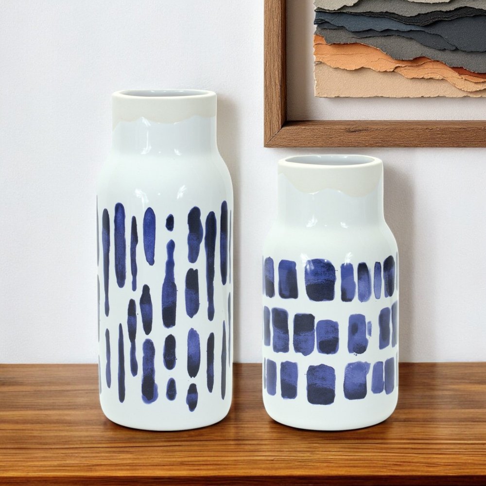 Set of two blue and white abstract ceramic cylinder vases from HomeRoots, decorative table vases with modern design.