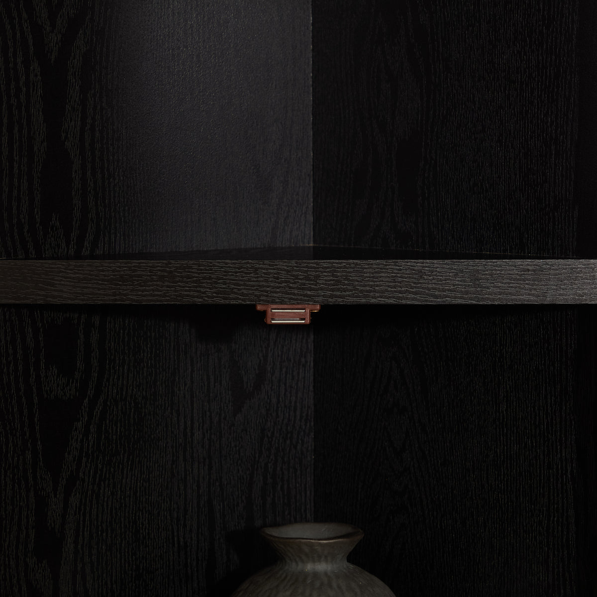 Corner pantry cabinet in matte black finish from Anthony & Home's Studio Collection, featuring shelves and storage space.
