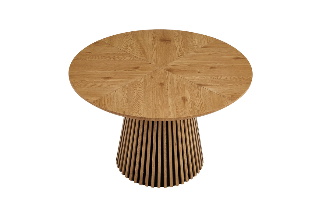 Solid wood round dining table from Anthony & Home's Atelier Collection, featuring a smooth, natural wood finish and sturdy design.