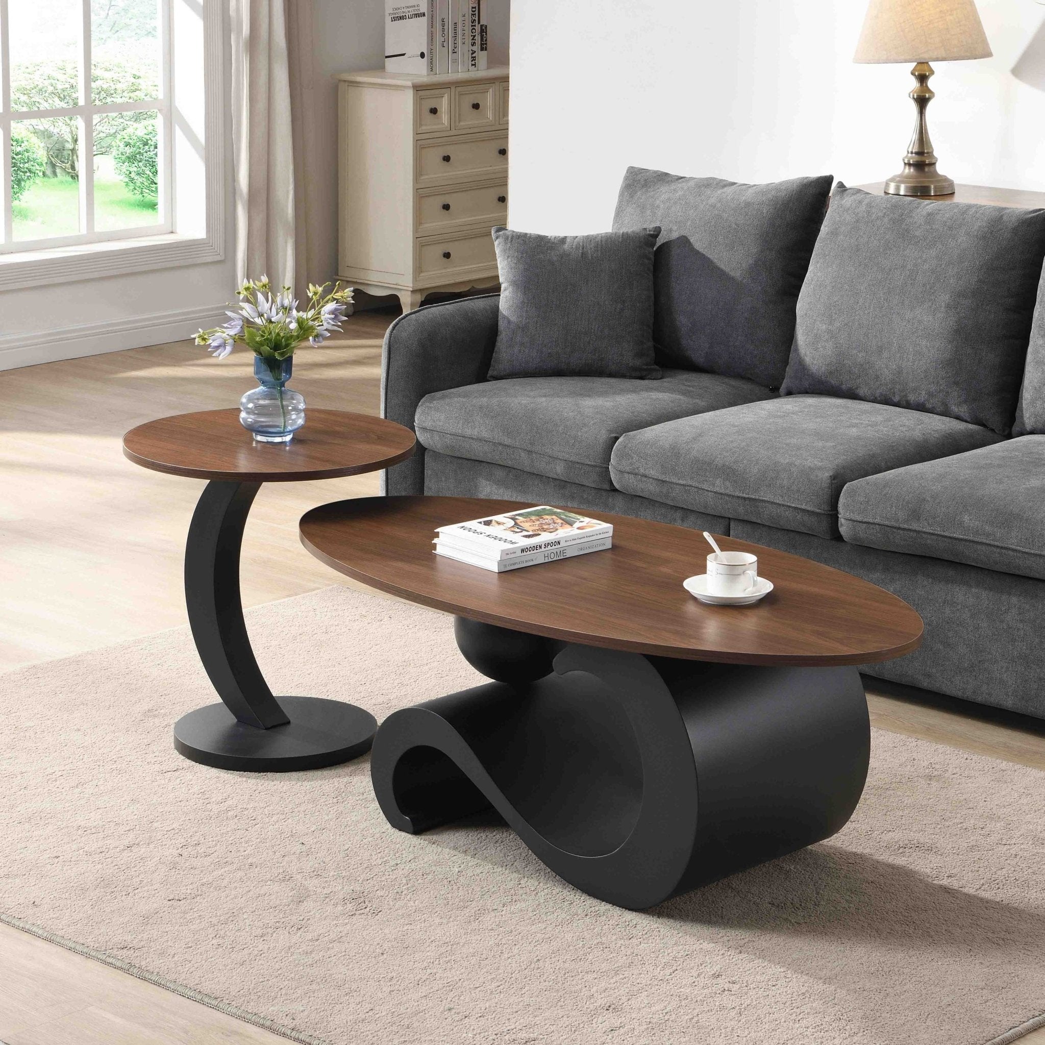 Set of black MDF nesting coffee tables with sleek metal bases by Anthony & Home, showcasing modern, space-saving design.