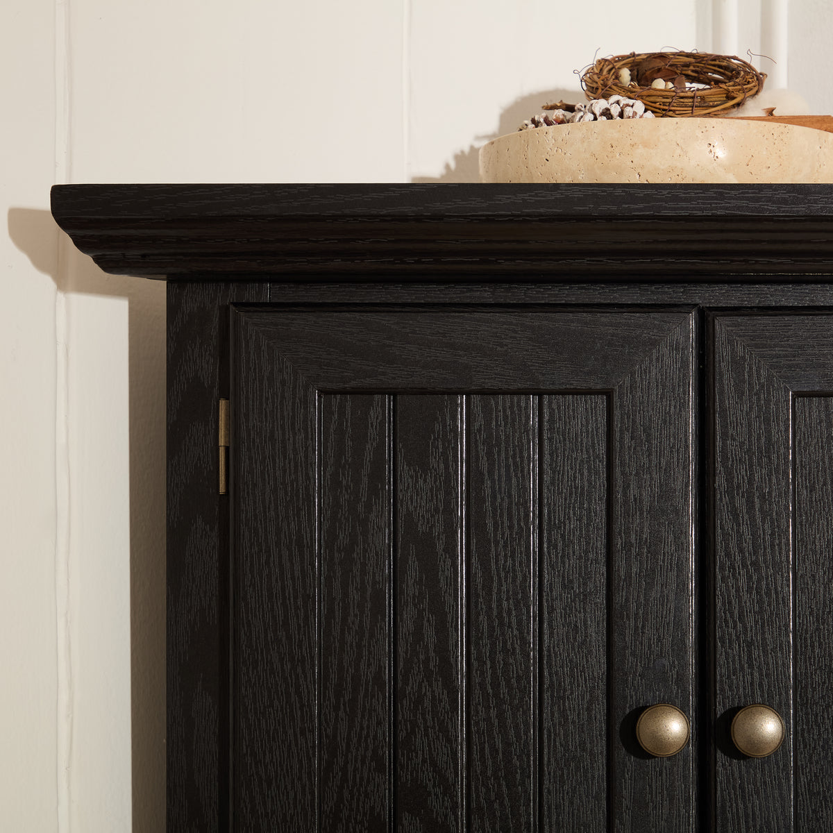 Corner pantry cabinet in matte black finish from Anthony & Home's Studio Collection, featuring shelves and storage compartments.