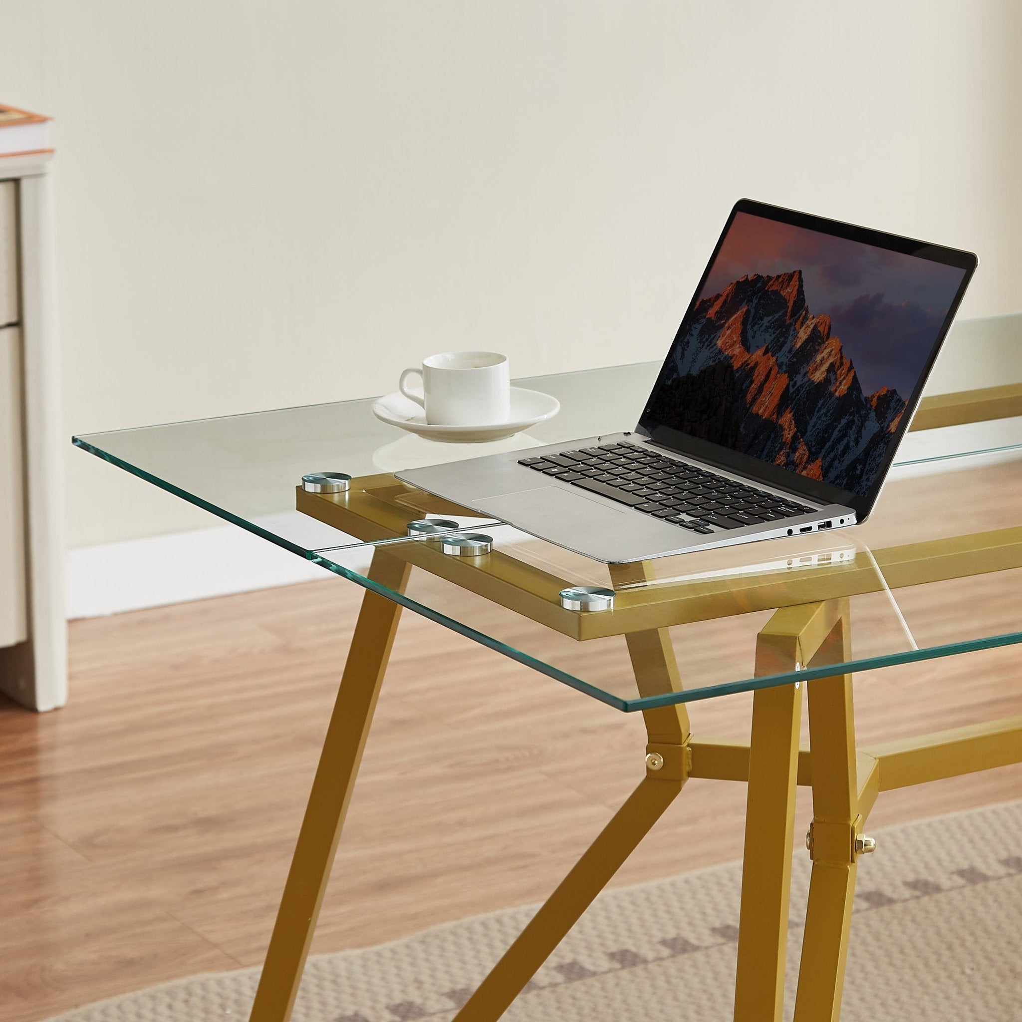 Rectangular glass dining table with gold finish from the Atelier Collection by Anthony & Home, featuring sleek modern design.