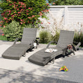 Outdoor wicker chaise lounge set with ergonomic wave design in grey, perfect for relaxing in a stylish garden space.