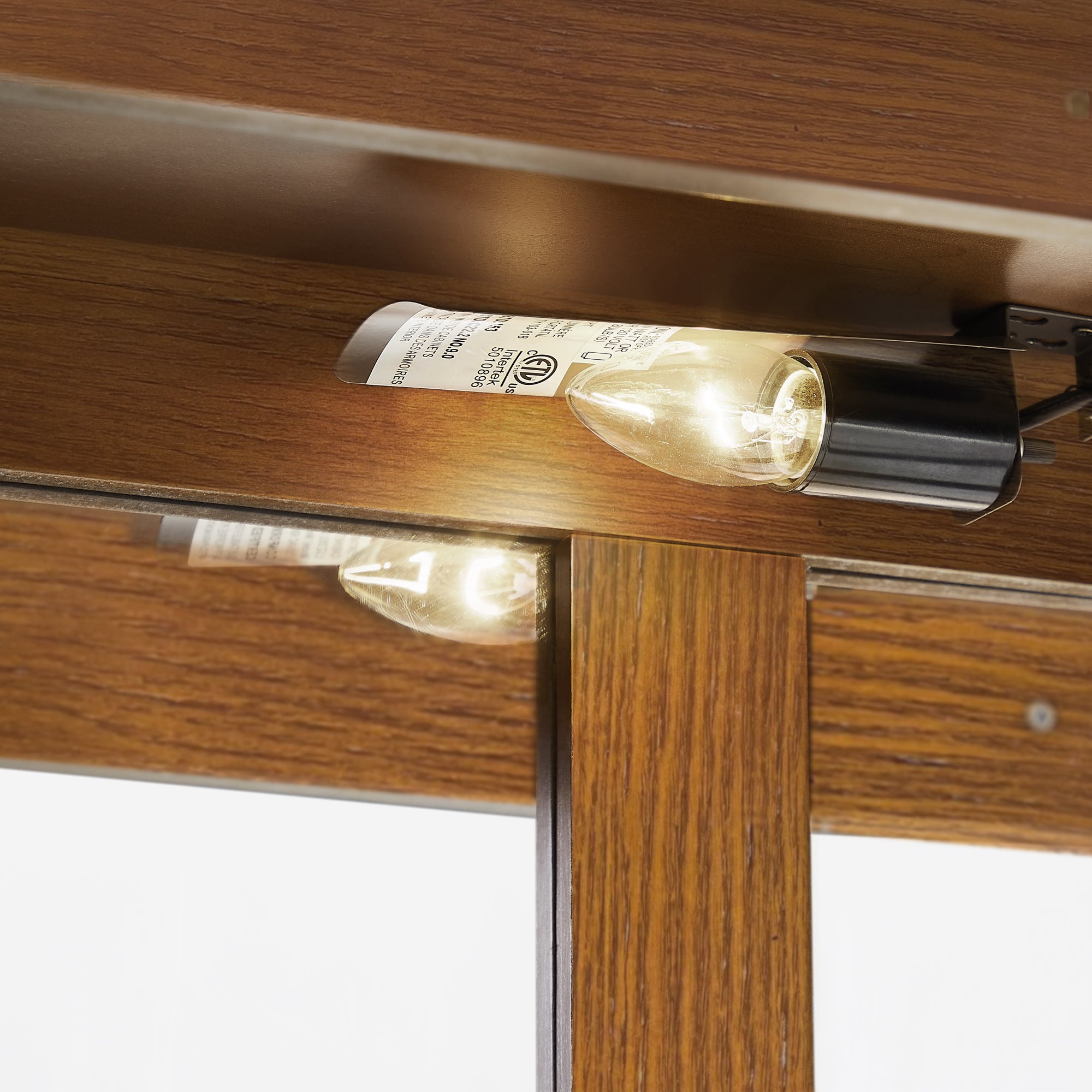 Oak finish lighted curio cabinet with mirrored back, showcasing glass shelves and elegant design by Anthony & Home.