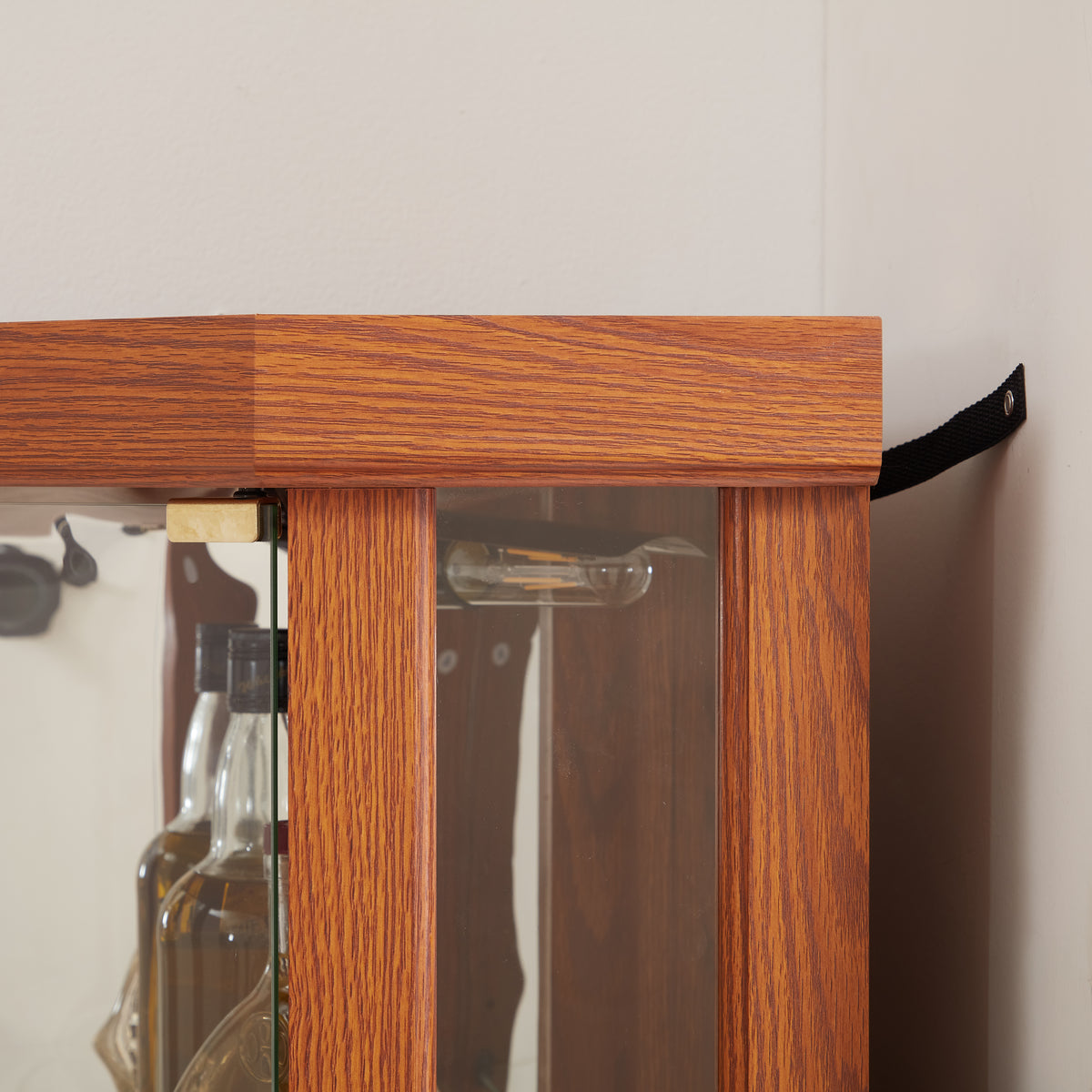 Dark oak corner curio cabinet with glass doors and built-in lighting by Anthony & Home, showcasing display shelves and elegant design.