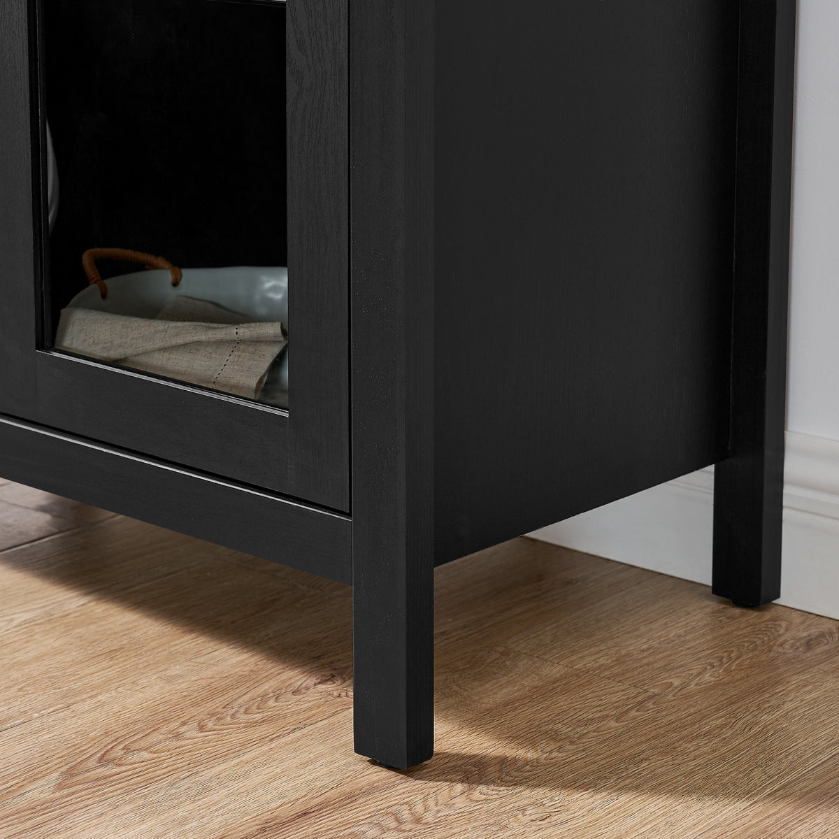 Black arched lamp cabinet with glass partition, designed by Anthony & Home, showcasing an elegant atelier-style furniture piece.