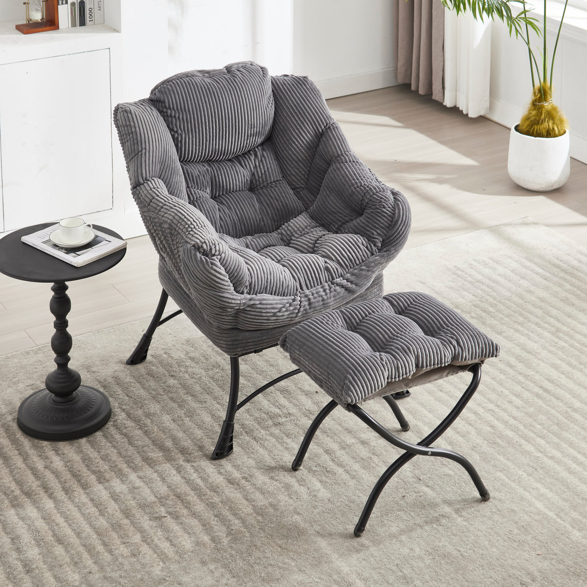 Grey upholstered lounge chair with matching ottoman and armrests, modern design from Anthony & Home.