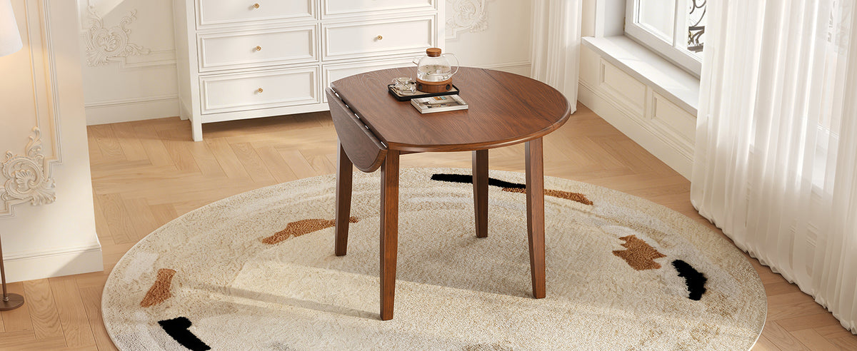 Anthony & Home Atelier Walnut Extendable Round Dining Table with 2-4 seating, featuring a sleek wooden surface and modern design.