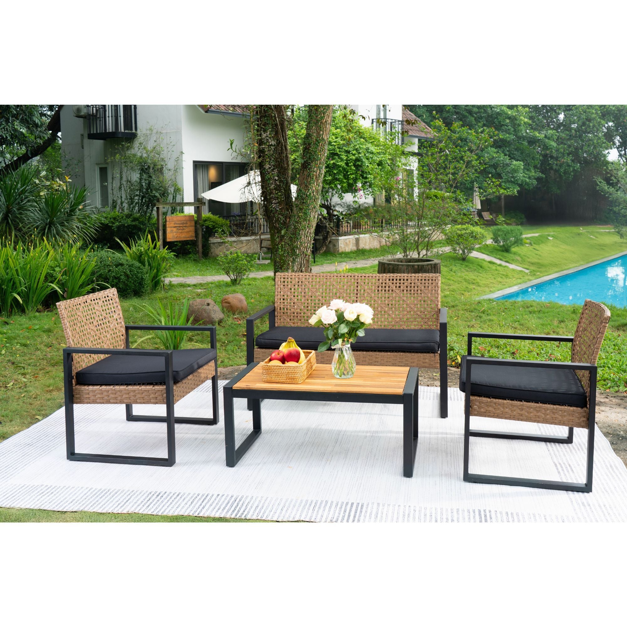Acacia wood outdoor 4-piece studio table set by Anthony & Home with matching chairs and a central table in a patio setting.