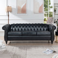 Anthony & Home Chesterfield rolled-arm sofa three-seater with tufted upholstery and wooden legs in a cozy living room setting.