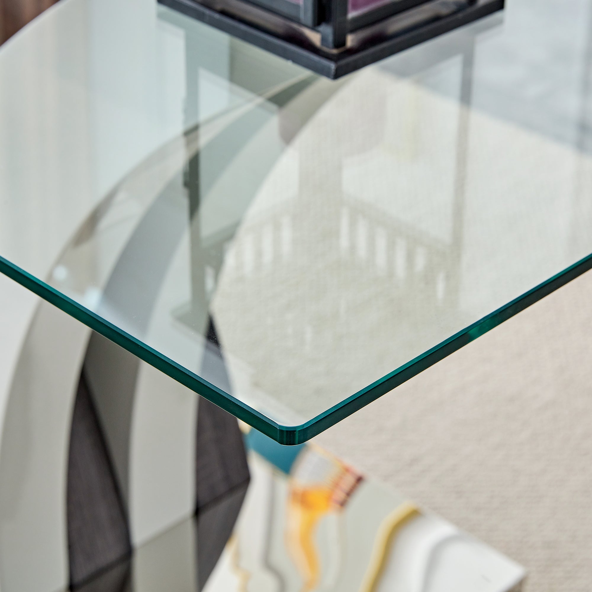Tempered glass dining table with MDF legs from Anthony & Home Studio Collection, modern and sleek design.