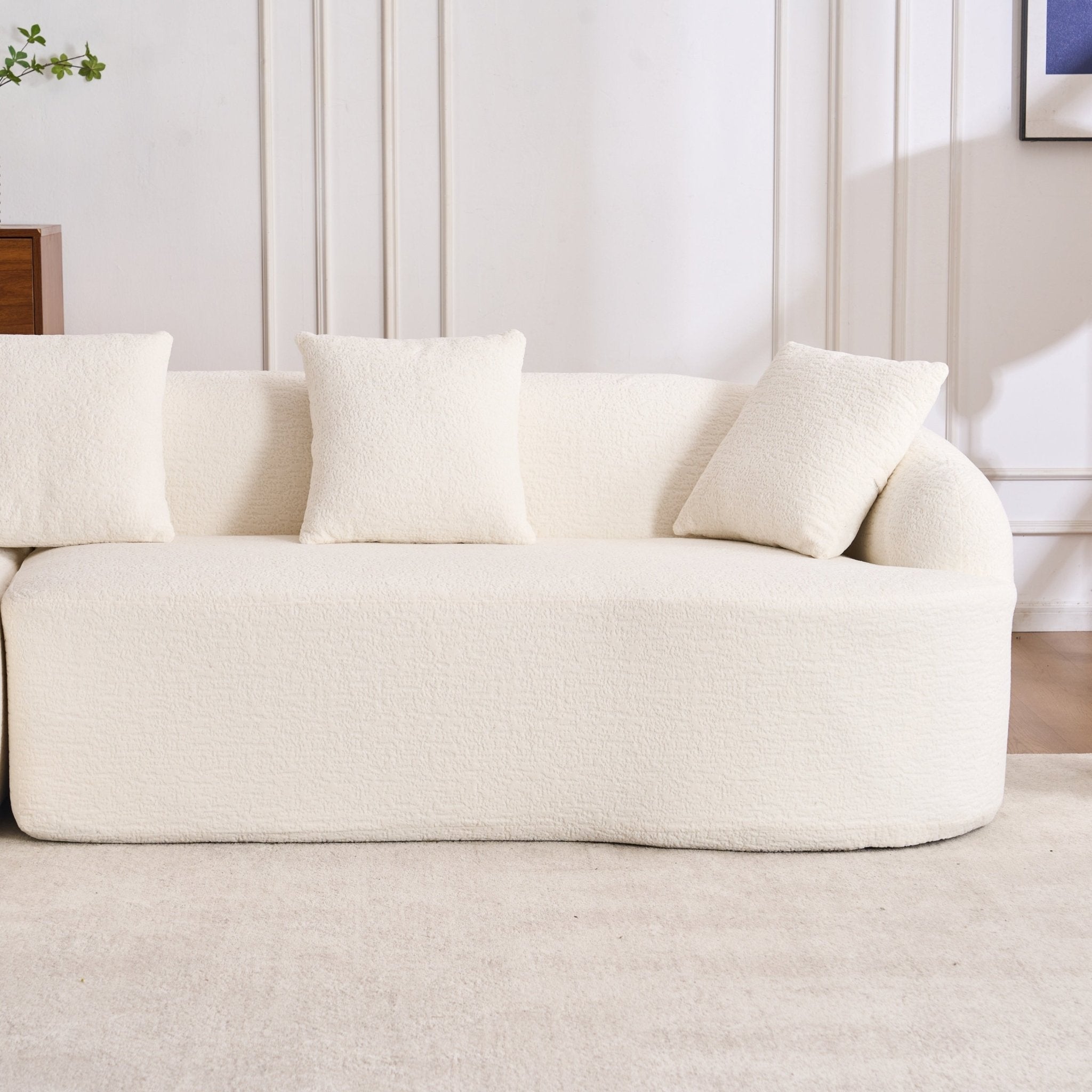 Anthony & Home Heritage Collection L-shaped sectional sofa with curved chaise, elegant minimalist design in neutral fabric.