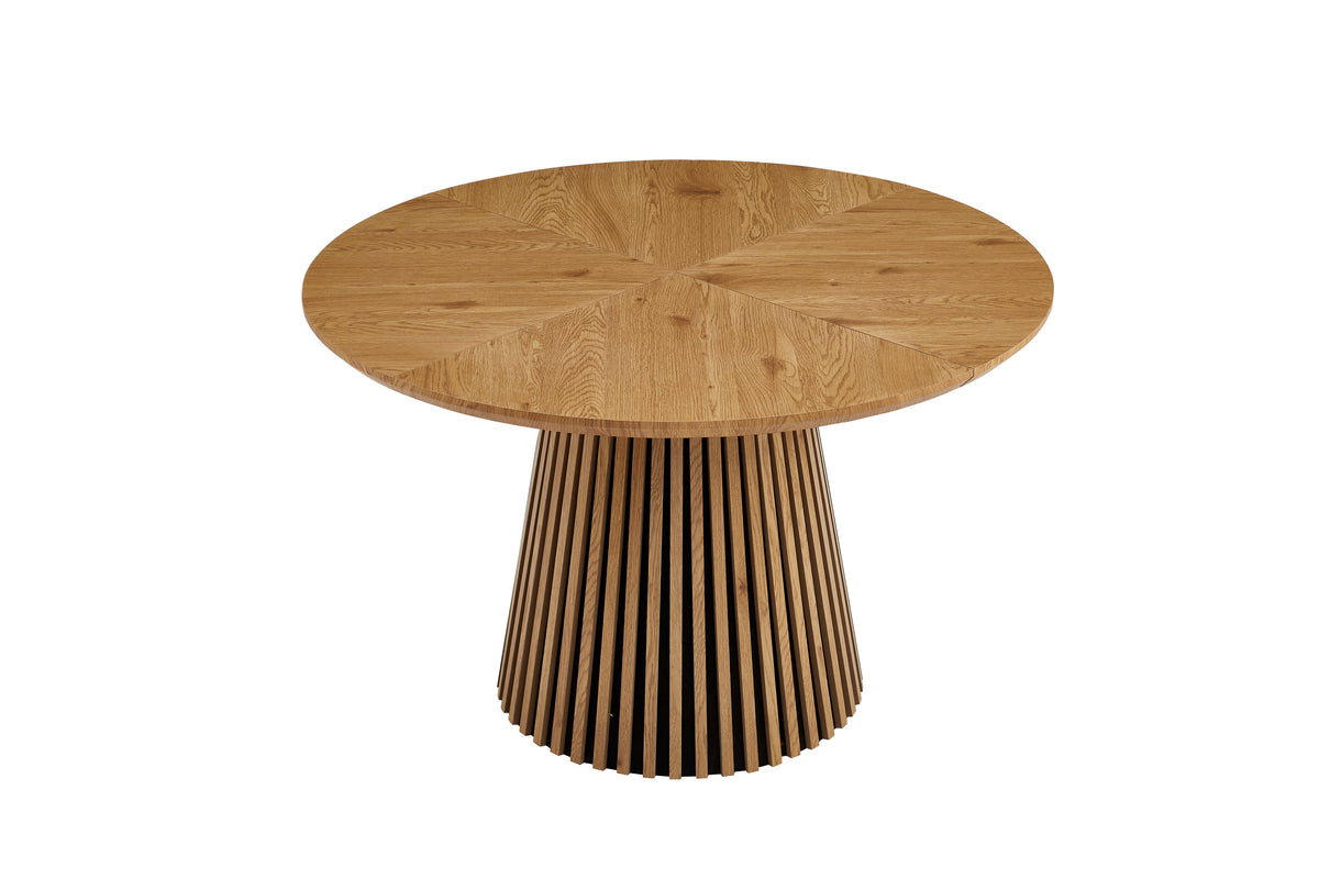 Round solid wood dining table from Anthony & Home's Atelier Collection with a smooth, polished surface and sturdy wooden legs.