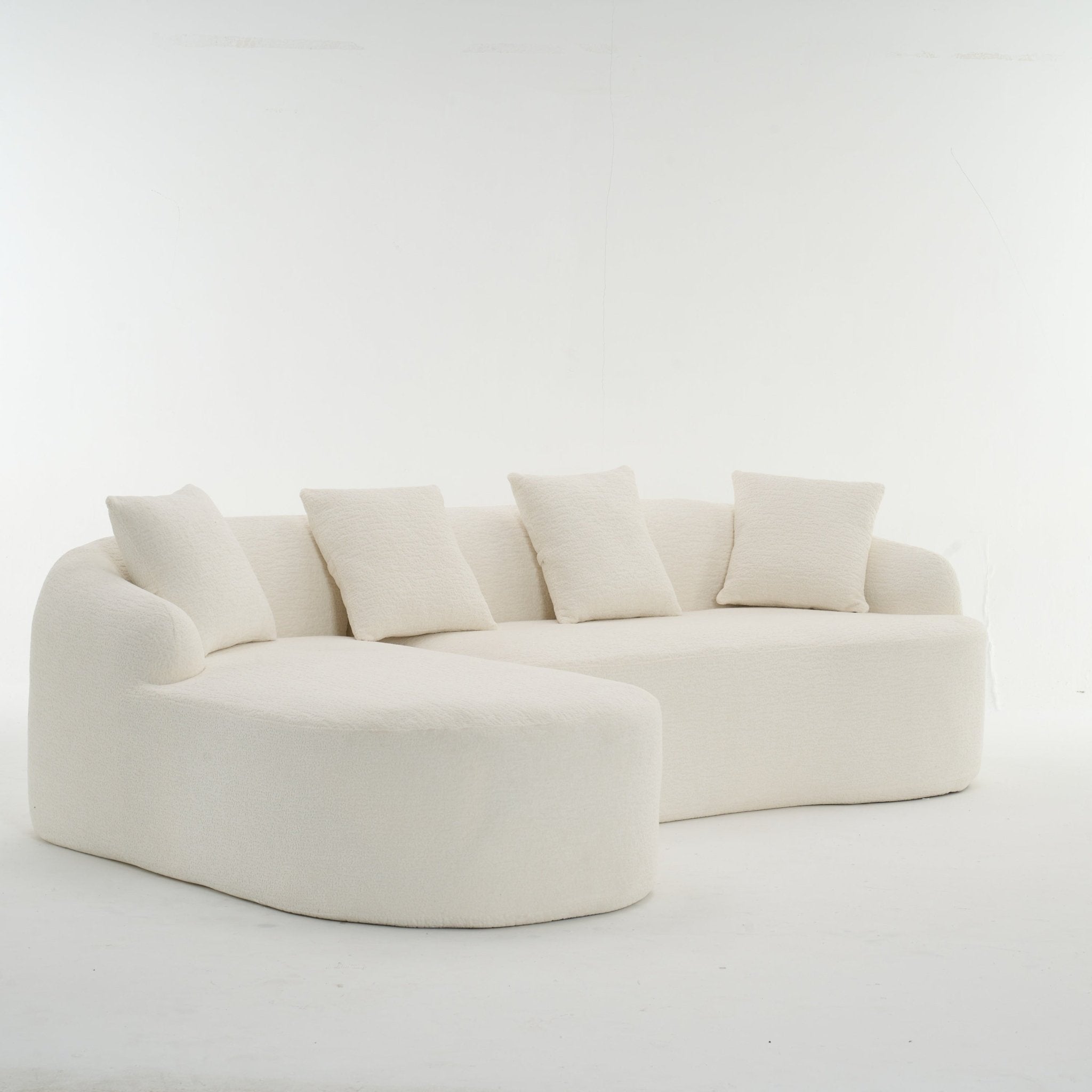 Anthony & Home Heritage Collection L-shaped sectional sofa with curved chaise in elegant minimalist design, shown from a side view.