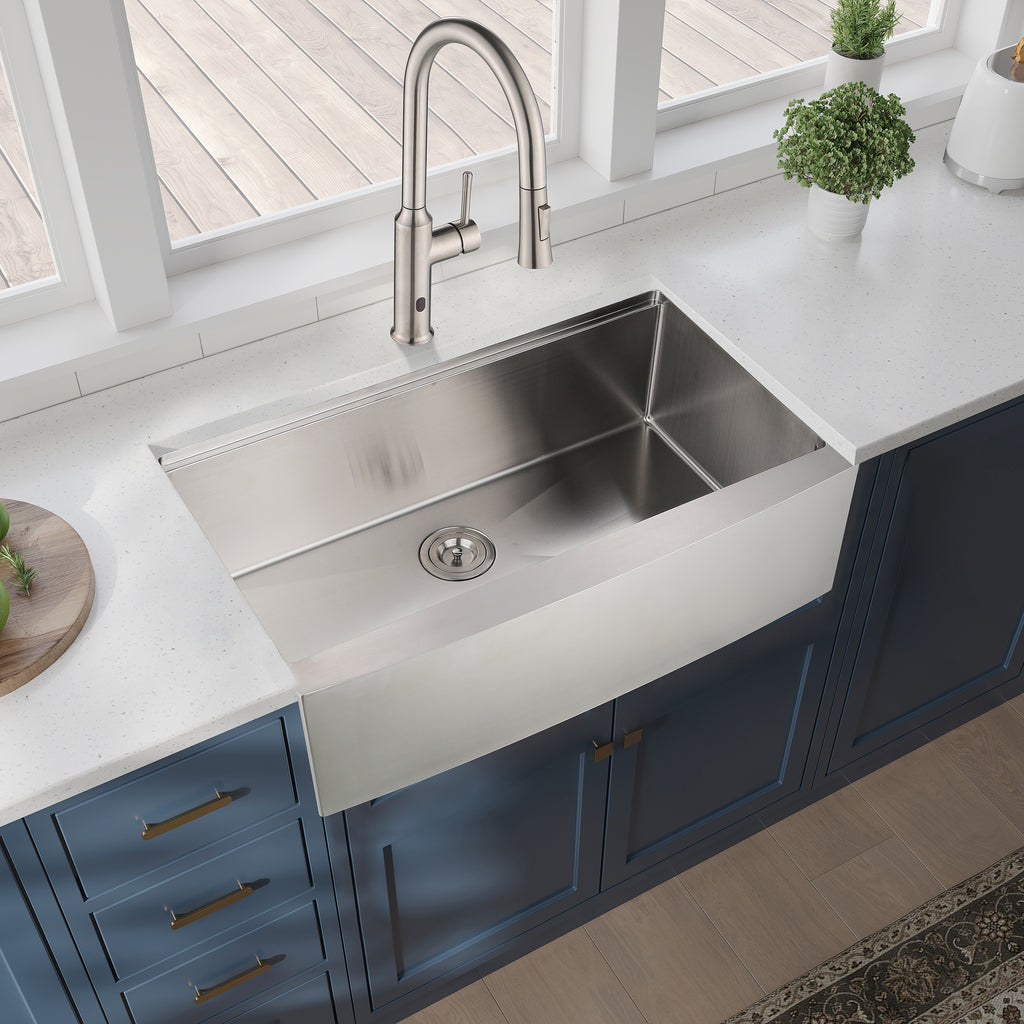 Stainless steel farmhouse apron kitchen sink workstation with spacious basin and durable finish, ideal for modern kitchen use.