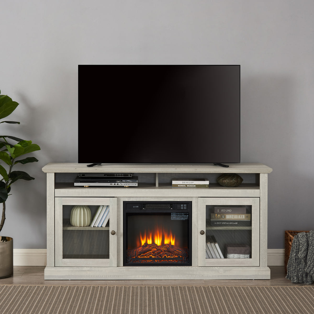 Stone gray finish studio TV media console with fireplace, showcasing modern design and built-in heating feature by Anthony & Home