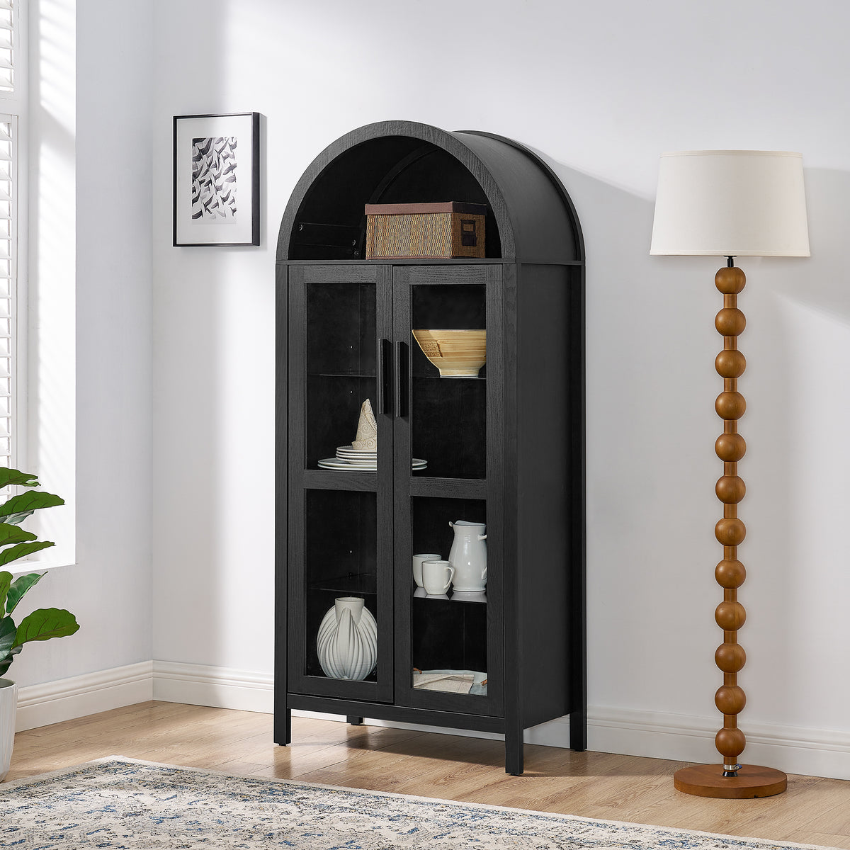 Black arched lamp cabinet with glass partition, designed by Anthony & Home, showcasing a stylish and modern interior accent piece.